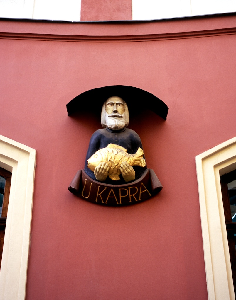 Building facade of man holding fish, Prague