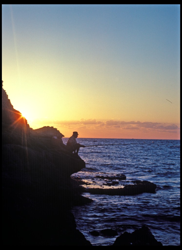 The Agean--Man fishes, while sun sets.